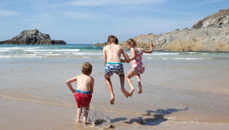 playing in the sand at Crantock Beach