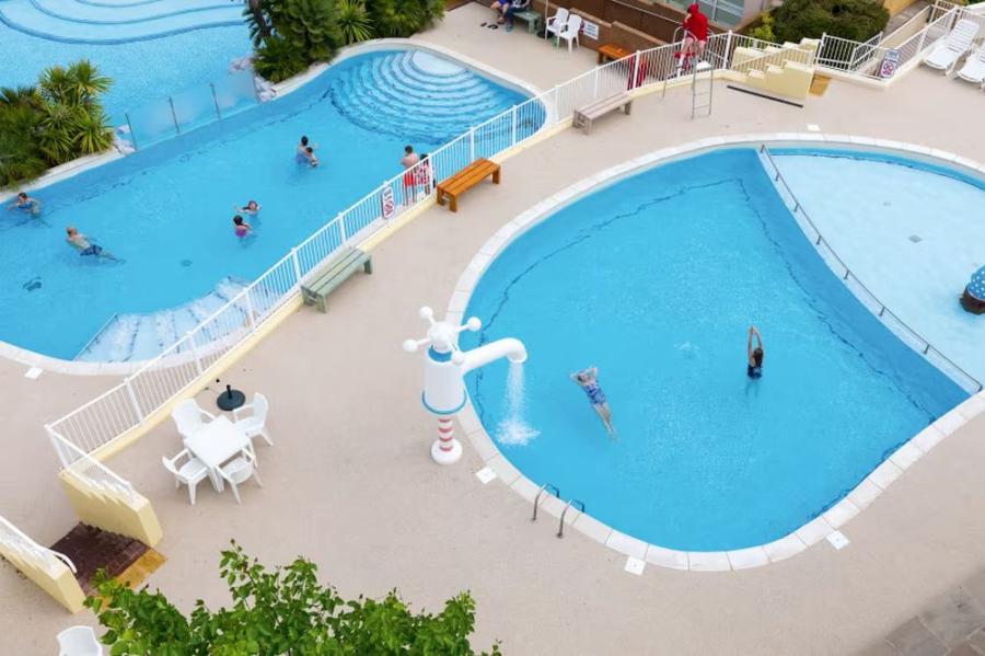 outdoor swimming pool complex at Devon Cliffs Holiday Park