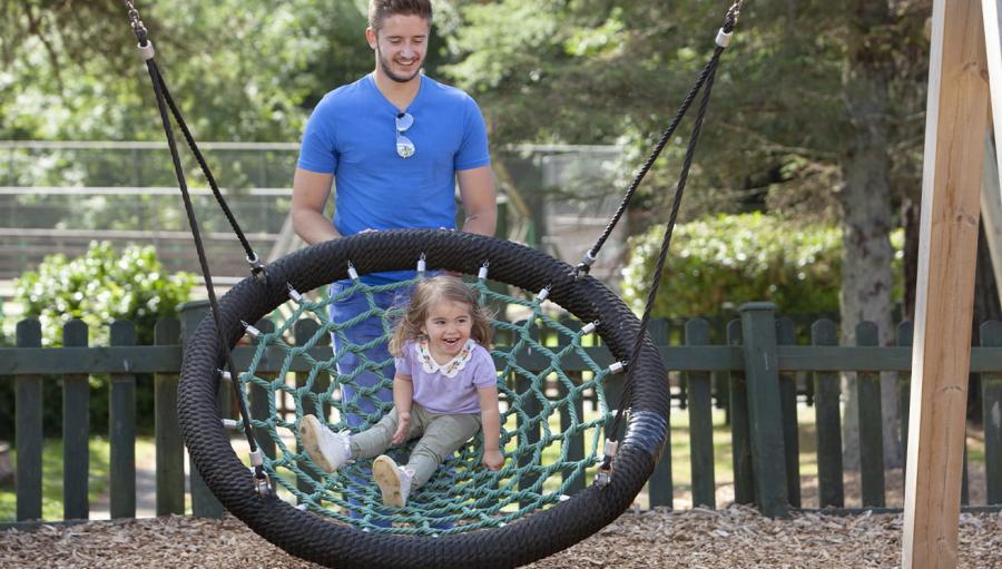 on the tyre swing in the adventure playground