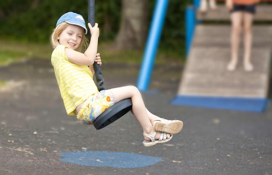 on the swings at South Bay Holiday Park in Brixham