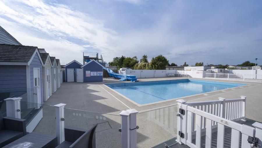 outdoor pool with beach huts