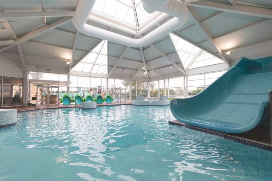 indoor swimming pool with slide at Cala Gran Holiday Park