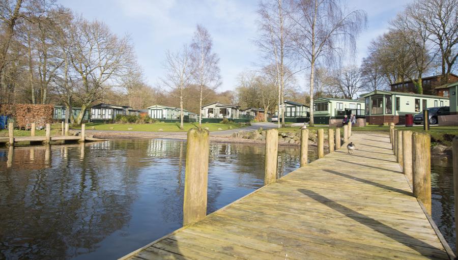 caravans by the pond at Fallbarrow Holiday Park