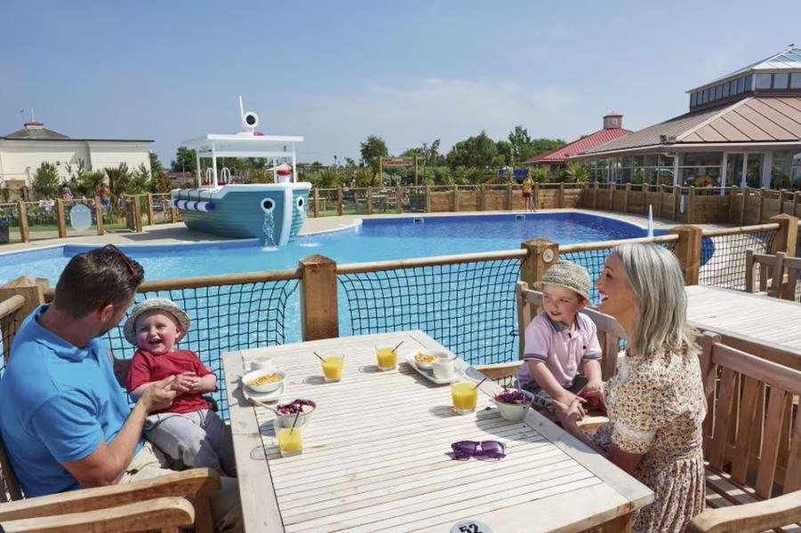 outside by the pool at Orchards Holiday Village