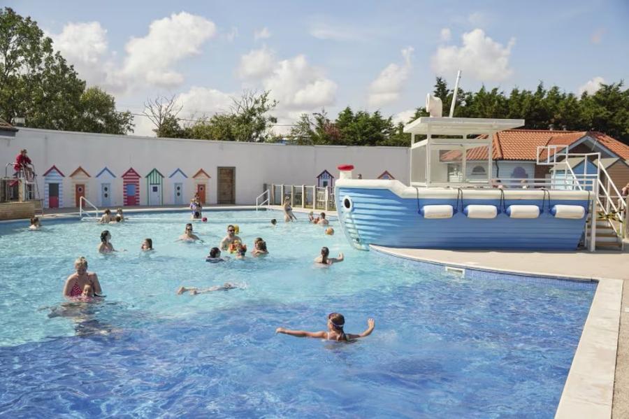 enjoying a swim in the outdoor pool at Orchards Holiday Village