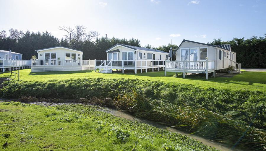 lodges by the stream at Valley Farm Holiday Park