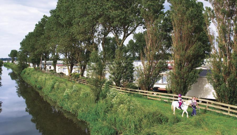 walks down by the river at Heacham Beach Holiday Park