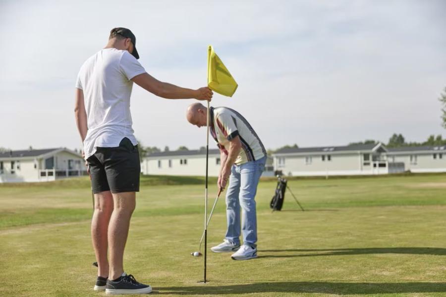 the golf course at Hopton Holiday Village with caravans and lodges