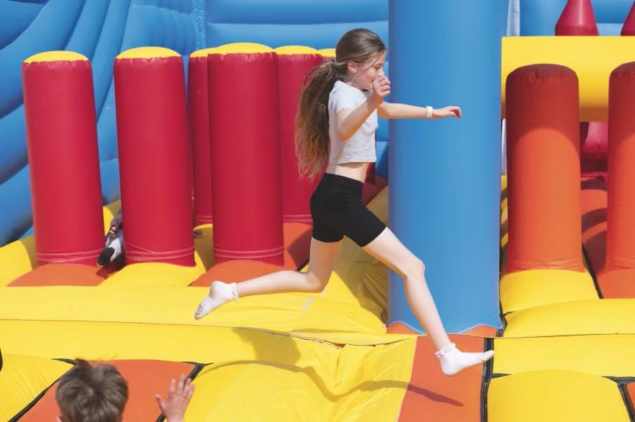 having fun on the inflatables at Hopton Holiday Village