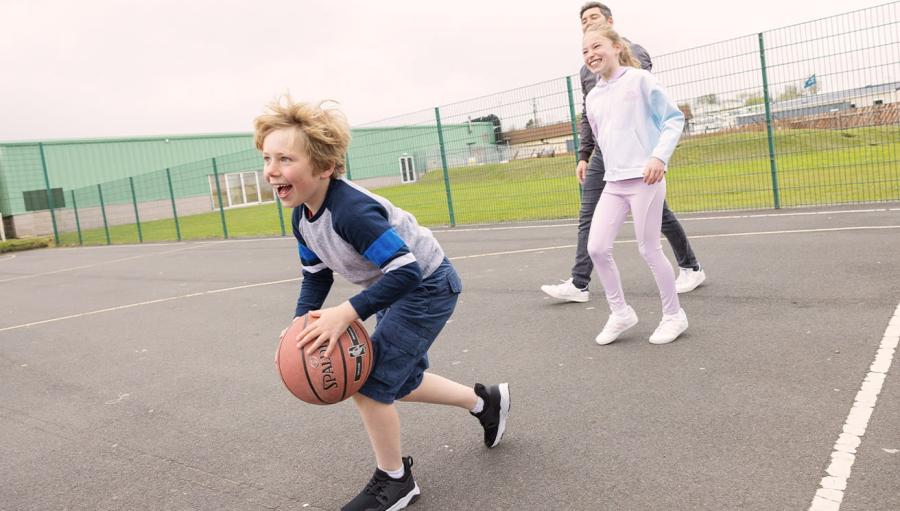 playing in the sports court at Sandy Bay Holiday Park