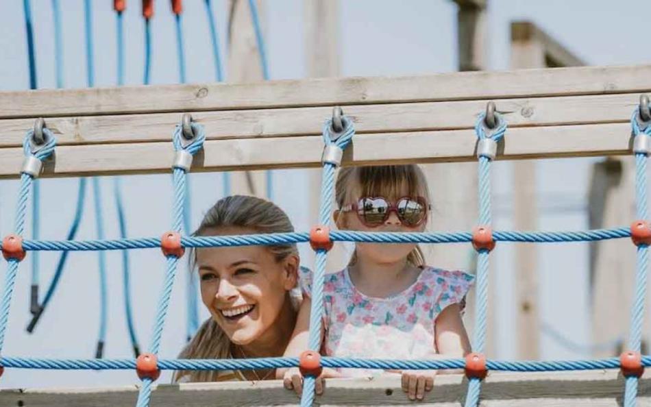 A Mother and Child Playing on the Adventure Playground on a Cornish Holiday Park