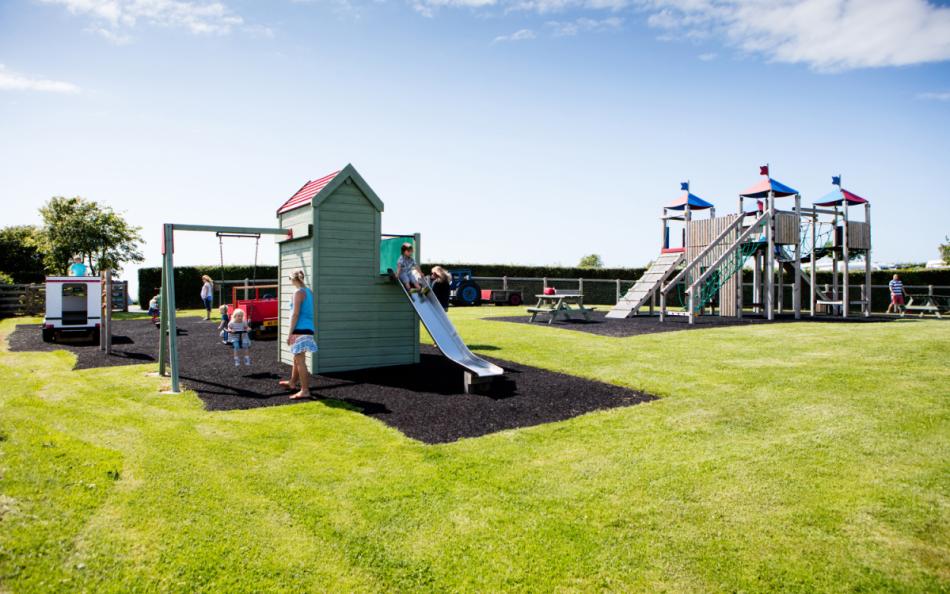 Children and Parents on a Playground on a Holiday Park near Bude in Cornwall