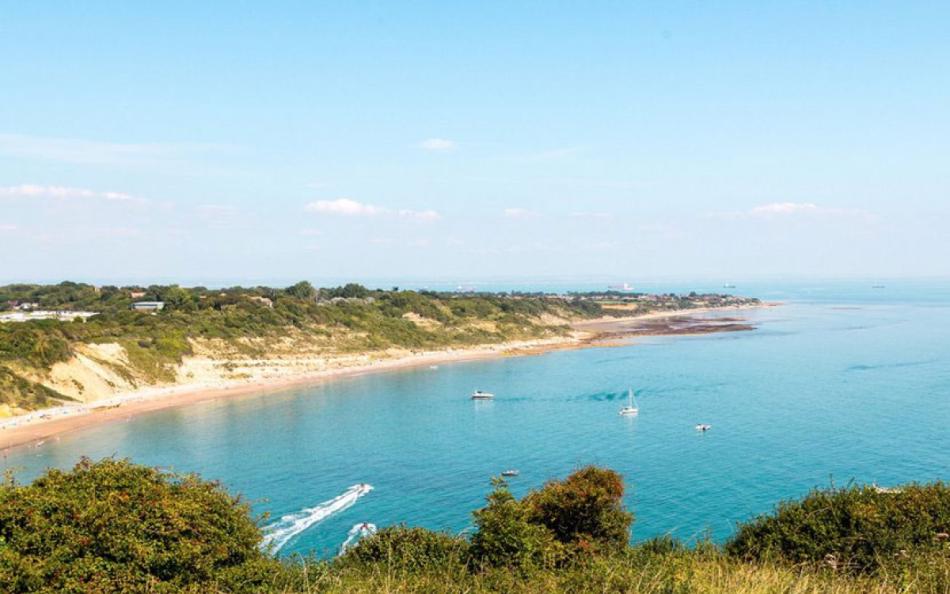 Boats in the Sea near the Away Resorts Whitecliff Bay Holiday Park